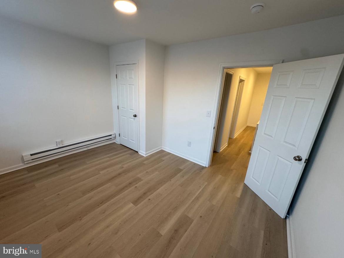 3252 Hope Street Philadelphia, PA 19140 - Photo 4 of 19 a view of an empty room with wooden floor and a window