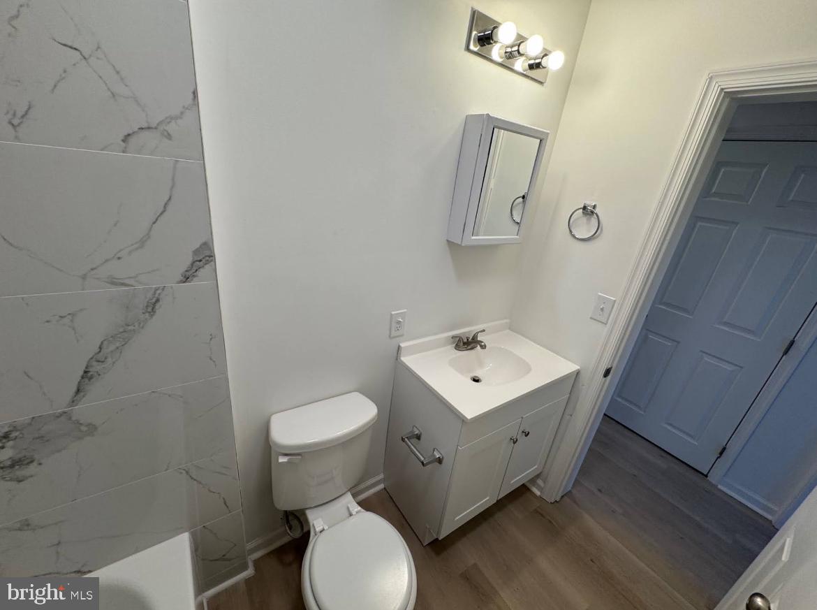 3252 Hope Street Philadelphia, PA 19140 - Photo 8 of 19 a bathroom with a toilet sink and mirror
