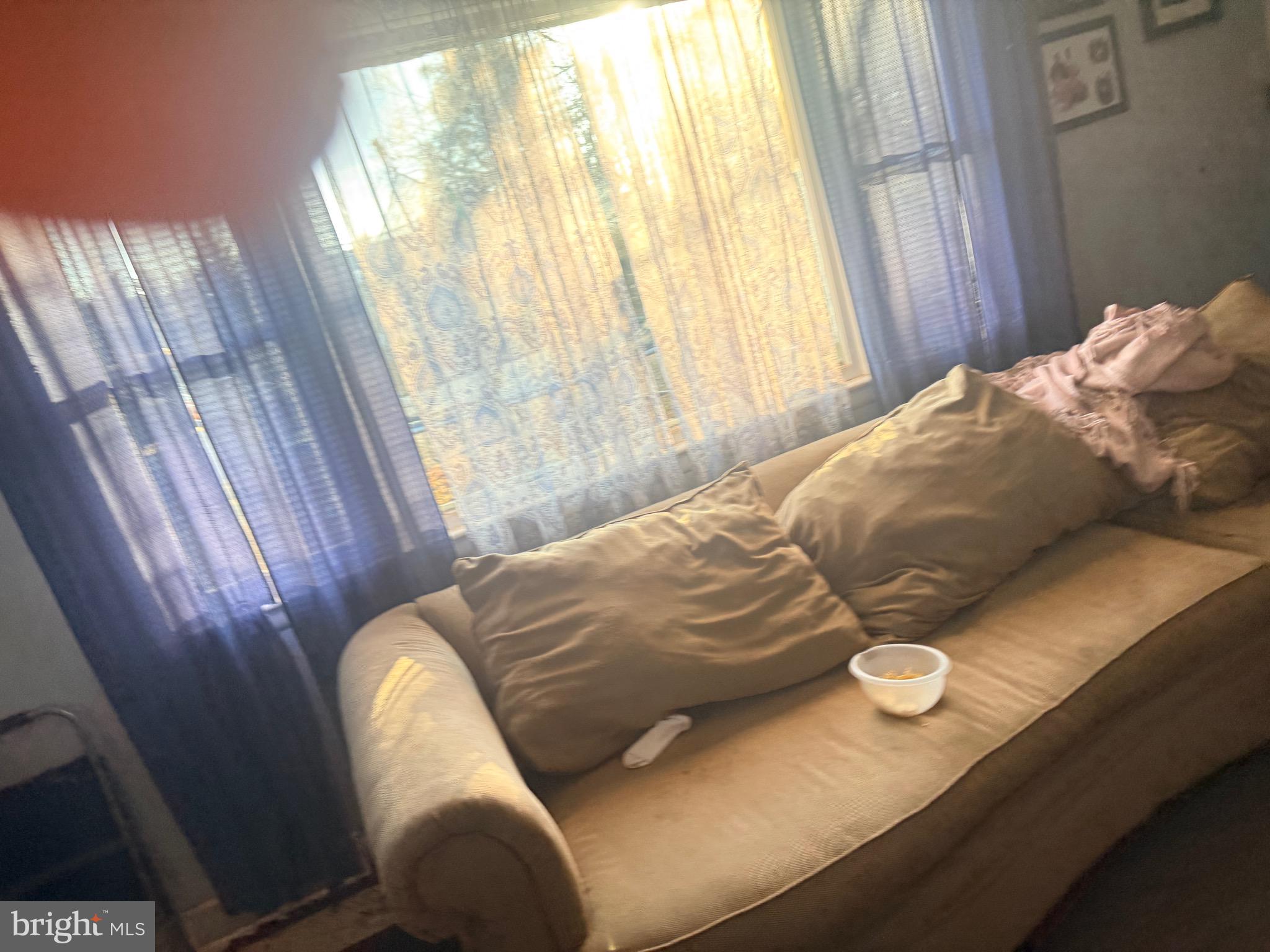 121 Elizabeth Street Culpeper, VA 22701 - Photo 13 of 22 a bed sitting in a bedroom next to a window