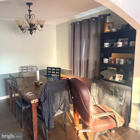 a view of a dining room with furniture and chandelier