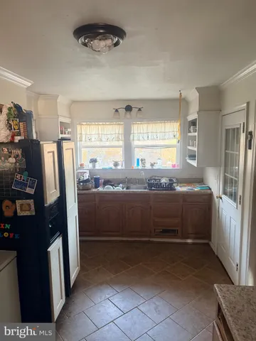 a kitchen with stainless steel appliances a refrigerator and a stove
