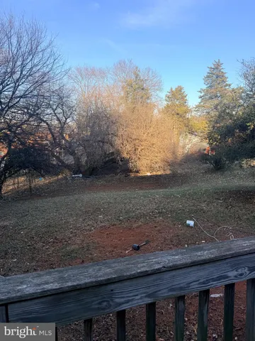 a view of a backyard with large trees