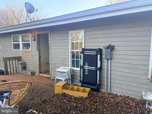 a backyard of a house with barbeque oven table and chairs