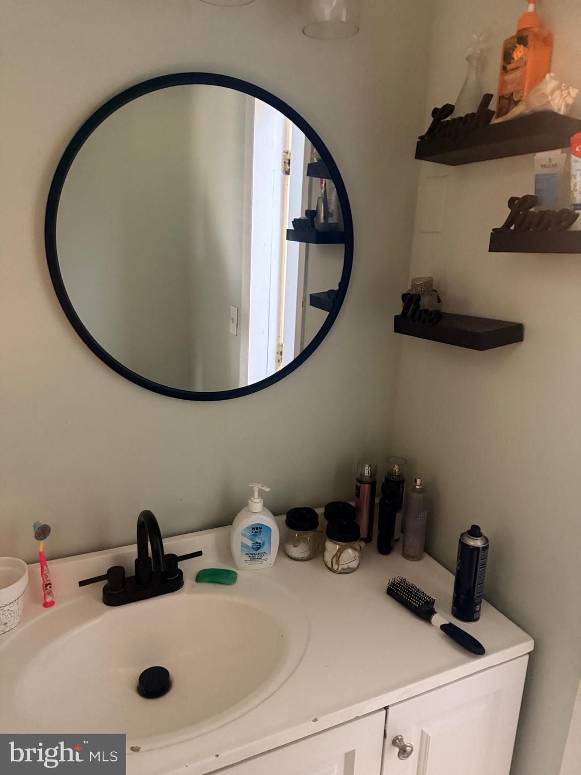 121 Elizabeth Street Culpeper, VA 22701 - Photo 9 of 22 a bathroom with a sink and a mirror
