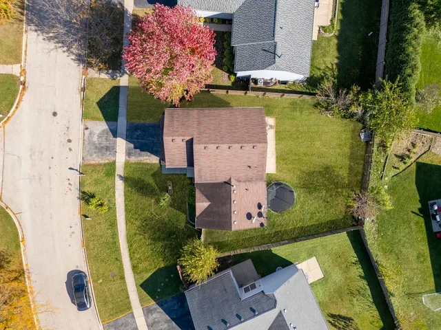 an aerial view of a house with a yard