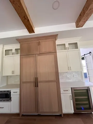 a room with wooden floor and cabinets