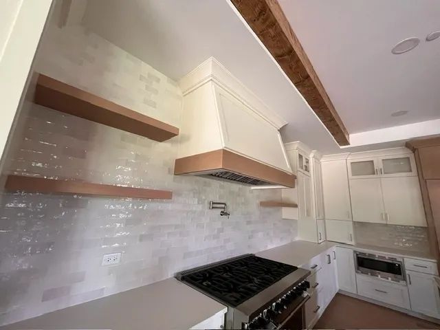 a stove top oven sitting inside of a kitchen