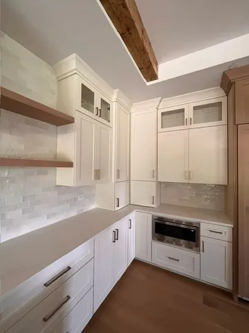 a view of a kitchen with a sink and dishwasher cabinet with wooden floor