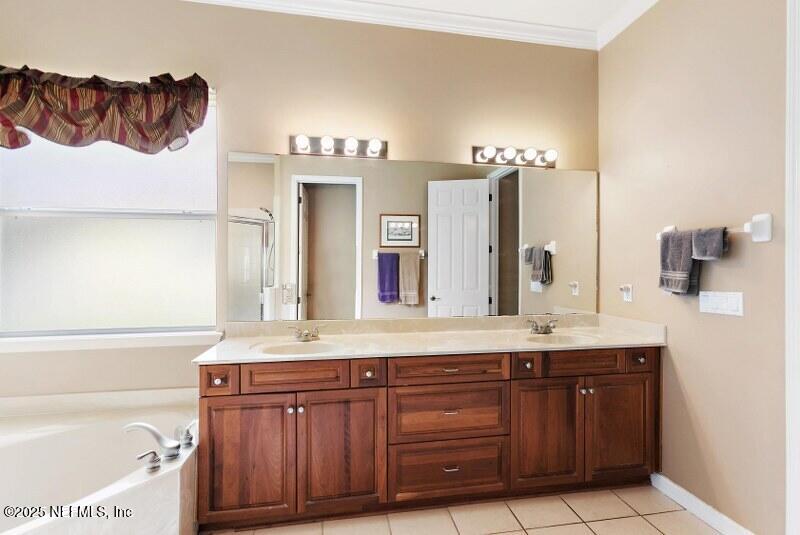 1330 Castle Pines Circle St. Augustine, FL 32092 - Photo 15 of 57 a bathroom with a sink a mirror and a bathtub