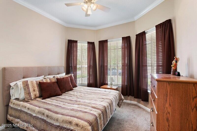 1330 Castle Pines Circle St. Augustine, FL 32092 - Photo 17 of 57 a bedroom with a large bed and a large window