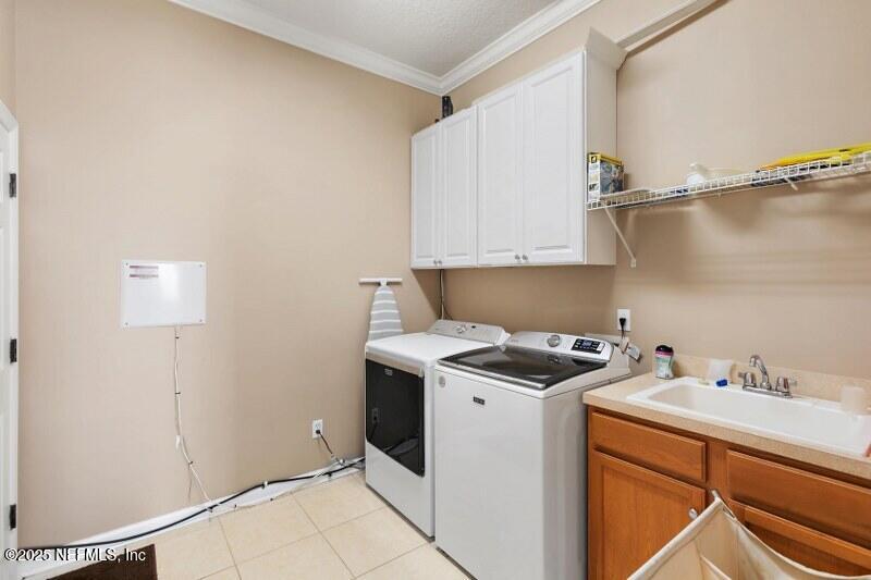 1330 Castle Pines Circle St. Augustine, FL 32092 - Photo 20 of 57 a utility room with cabinets washer and dryer