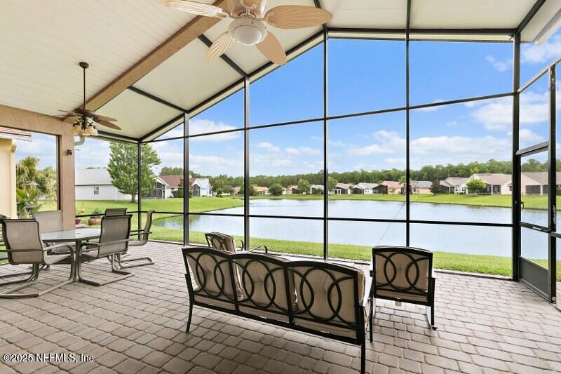 1330 Castle Pines Circle St. Augustine, FL 32092 - Photo 21 of 57 a living room with furniture and a floor to ceiling window