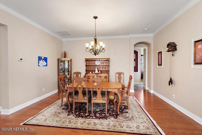 1330 Castle Pines Circle St. Augustine, FL 32092 - Photo 7 of 57 a dining room with furniture a rug and wooden floor