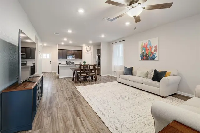 a living room with furniture and kitchen view