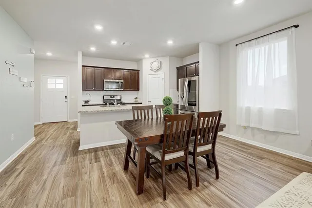 a dining room with furniture and wooden floor