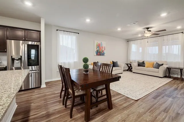 a view of a a dining room with furniture window and wooden floor
