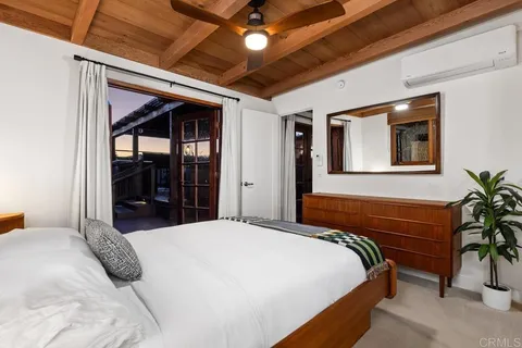 a spacious bedroom with a large bed and a large window