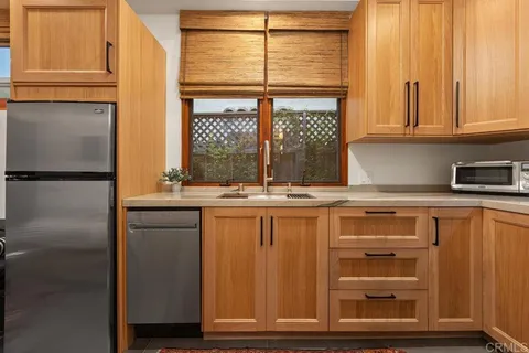 a kitchen with stainless steel appliances granite countertop a sink and a microwave