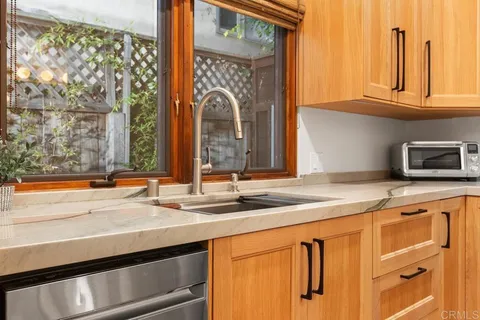 a bathroom with a sink vanity granite and toilet