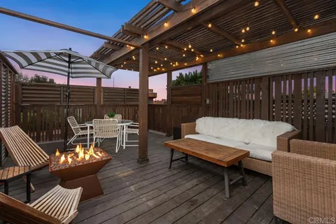 a outdoor living space with furniture and a fireplace
