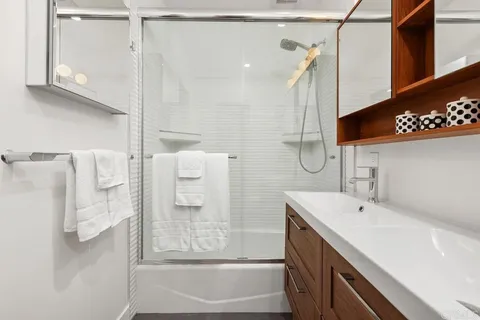 a patio with glass top table and chairs