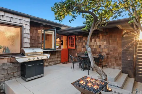 a roof deck with a table and chairs