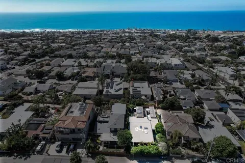 an aerial view of residential houses with city view