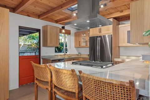 a kitchen with stainless steel appliances granite countertop a refrigerator sink and microwave