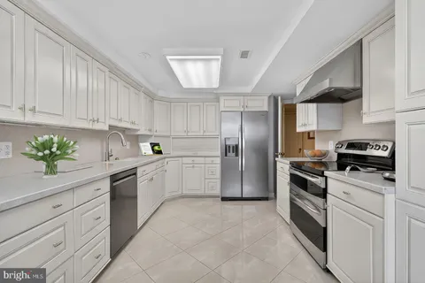 a kitchen with cabinets stainless steel appliances and a counter space