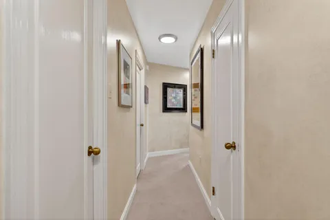 a view of a hallway with wooden floor