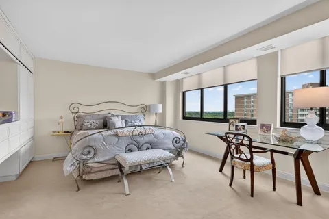 a bedroom with two beds and a large window