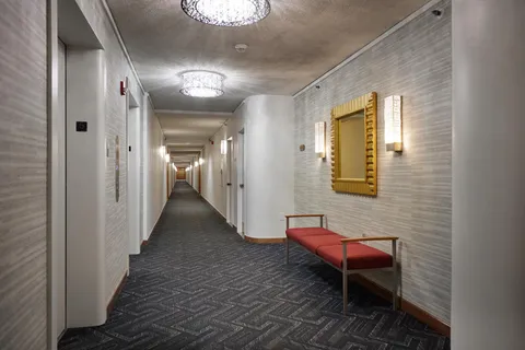 a view of a hallway with seating area