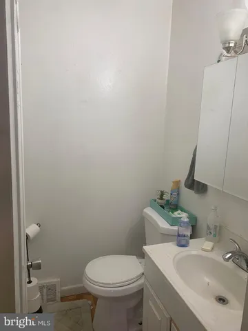 a bathroom with a sink toilet and a mirror