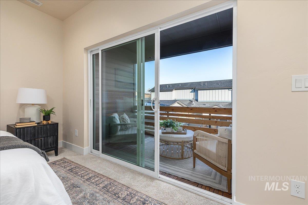 1433 North Bluffs Ridge Lane Boise, ID 83704 - Photo 10 of 18 Bedroom featuring light colored carpet and access to outside
