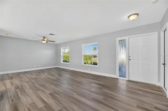 a view of a kitchen with wooden floor and a kitchen