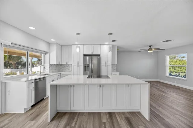 a kitchen with granite countertop a sink and a window