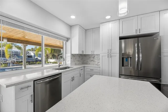 a bathroom with a double vanity sink a toilet and a mirror