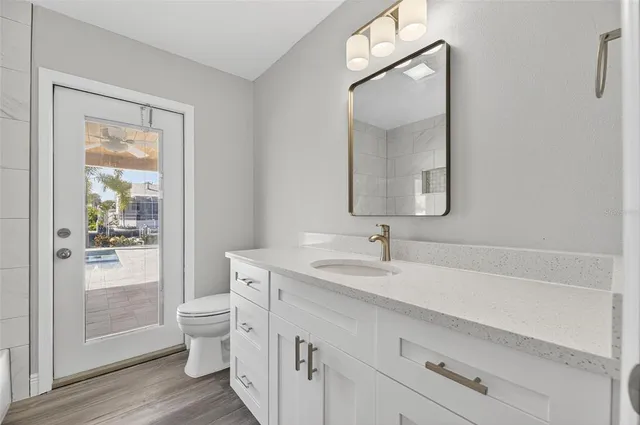 a view of a ocean with boats and trees in the background