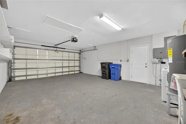 an aerial view of a house with a garden and lake view