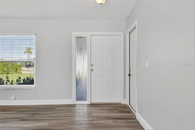 a view of a kitchen with wooden floor and a kitchen space