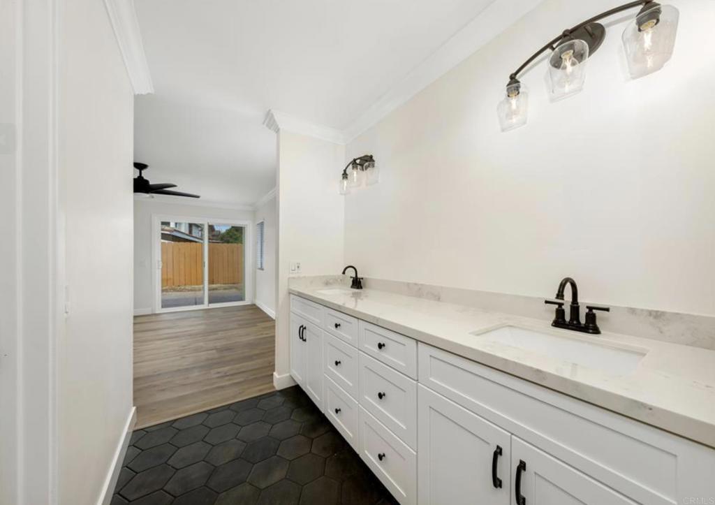 748 Cholla Road Chula Vista, CA 91910 - Photo 17 of 20 a bathroom with a double vanity sink a mirror and shower