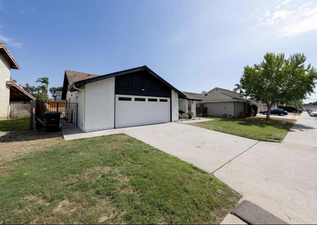 748 Cholla Road Chula Vista, CA 91910 - Photo 2 of 20 a front view of a house with a yard and garage