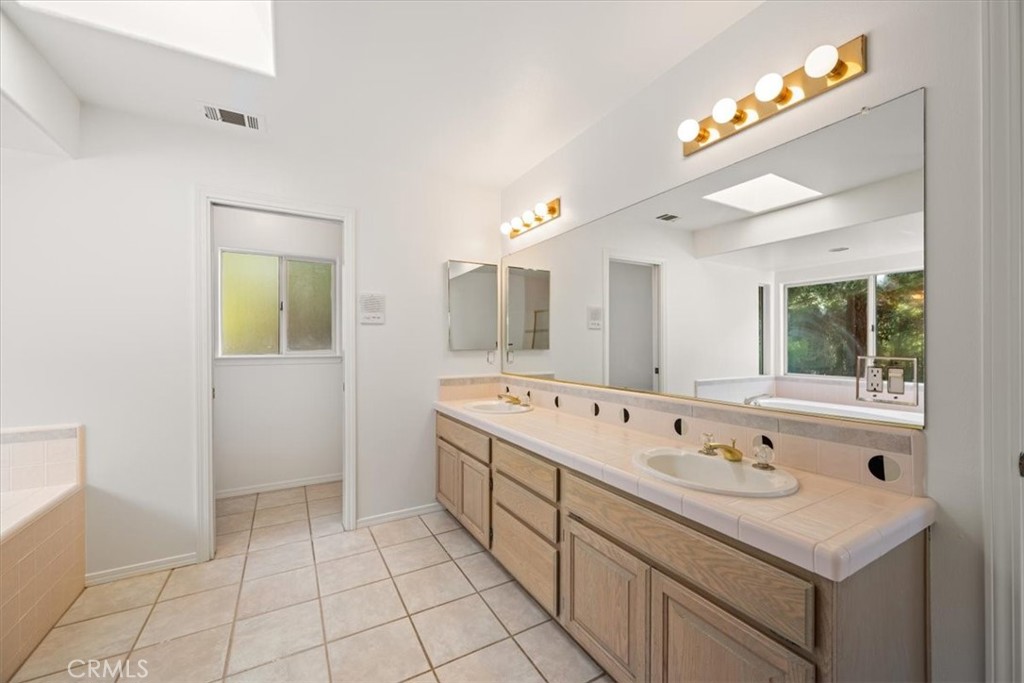 765 Ridgemont Way Arroyo Grande, CA 93420 - Photo 17 of 45 a spacious bathroom with a tub sink and mirror