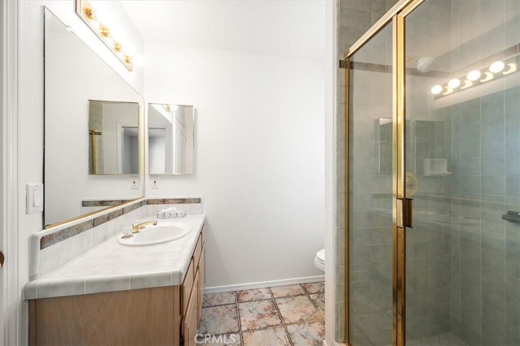 765 Ridgemont Way Arroyo Grande, CA 93420 - Photo 21 of 45 a bathroom with a sink a toilet and shower