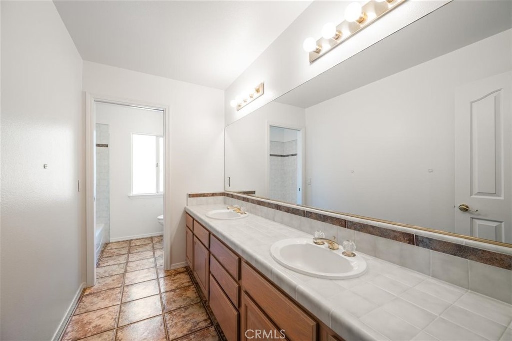 765 Ridgemont Way Arroyo Grande, CA 93420 - Photo 24 of 45 a bathroom with a granite countertop sink and a mirror
