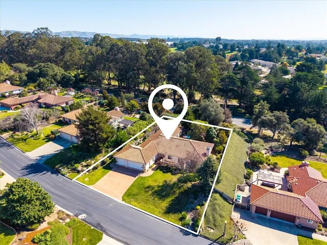 an aerial view of residential houses with outdoor space and swimming pool