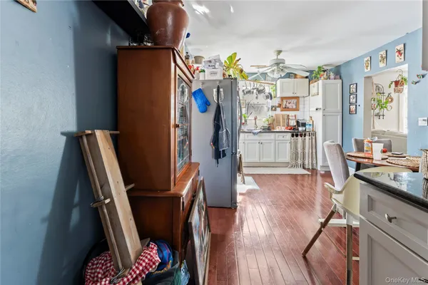 a kitchen with stainless steel appliances granite countertop a refrigerator a stove a sink dishwasher and wooden floor