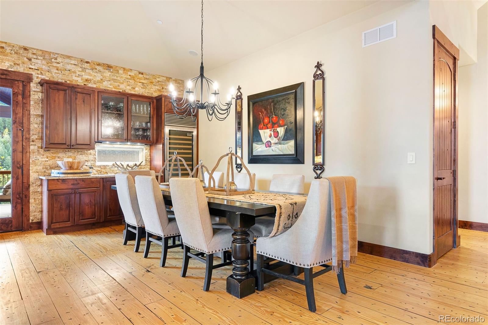 610 Clear Creek Road Evergreen, CO 80439 - Photo 12 of 50 a view of a dining room with furniture wooden floor and chandelier
