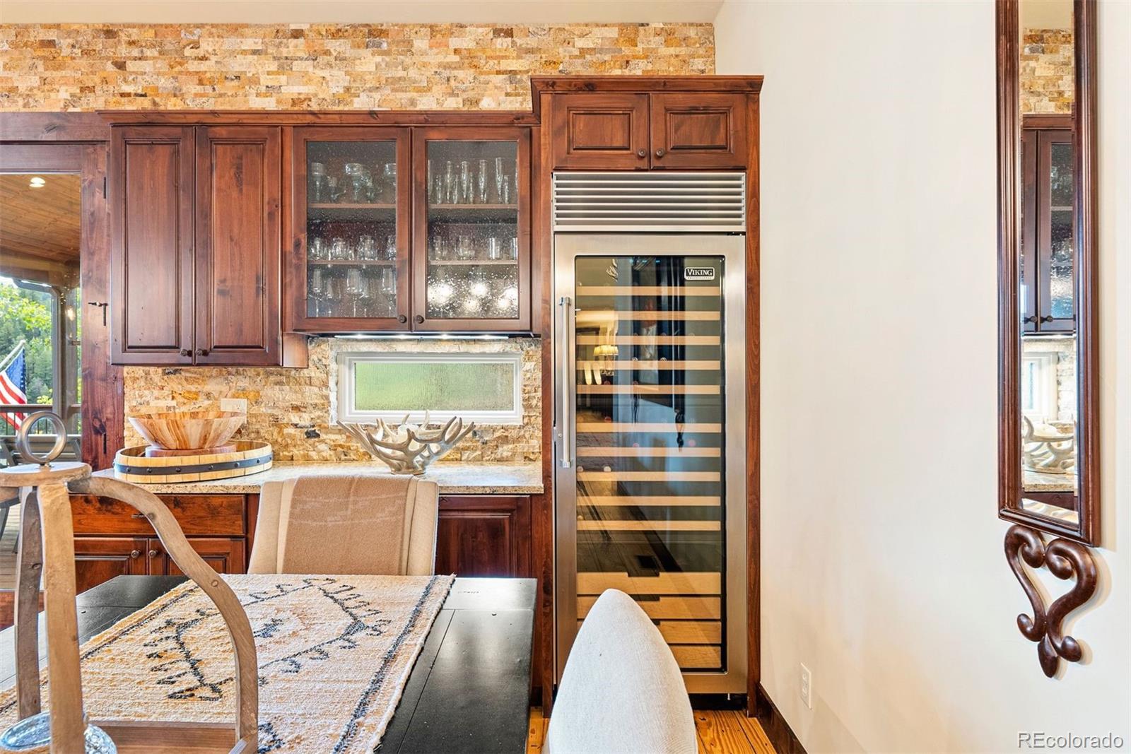 610 Clear Creek Road Evergreen, CO 80439 - Photo 13 of 50 a view of a kitchen with kitchen island granite countertop a refrigerator and a stove