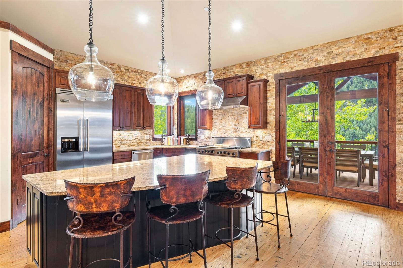 610 Clear Creek Road Evergreen, CO 80439 - Photo 14 of 50 a large kitchen with a table and chairs